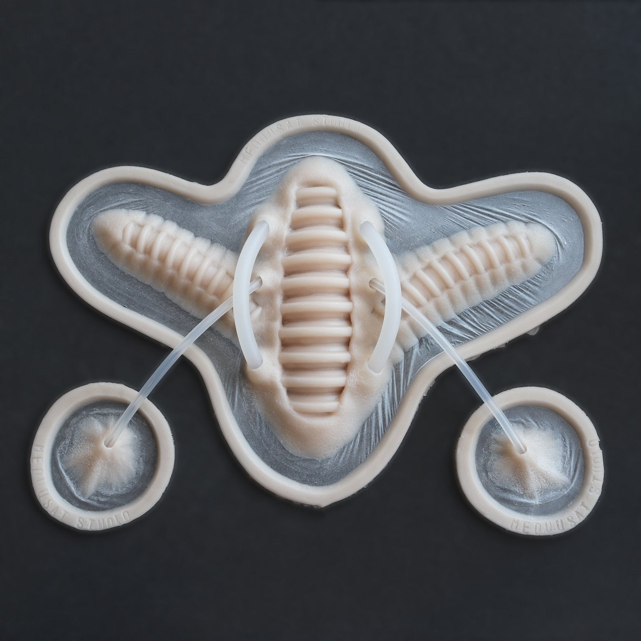 Cyborg Neck Piece - Silicone makeup prosthetic in vanilla shade on a black surface