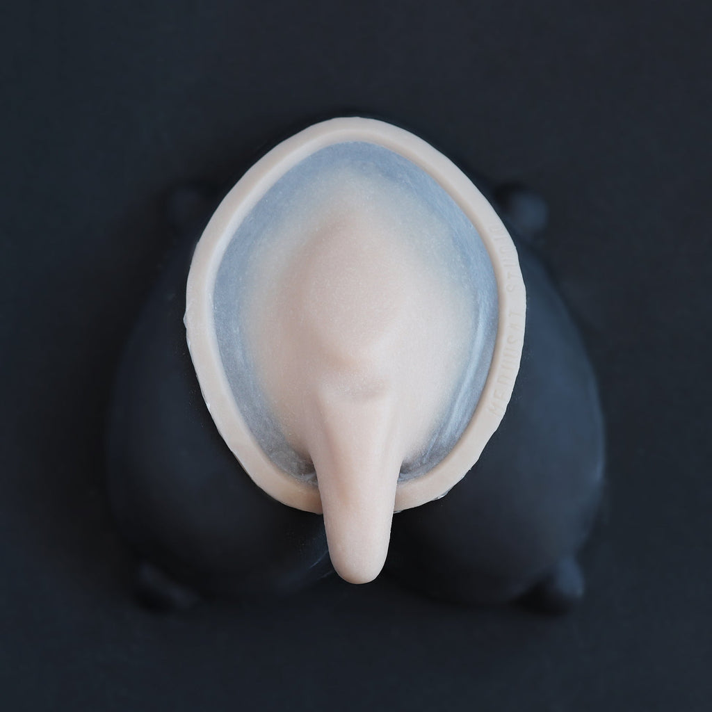 Demon Tail - Silicone makeup prosthetic in vanilla shade on a black surface