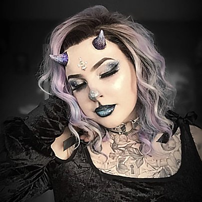 Woman with pastel lilac hair wearing lilac devil horns