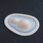 Double Subdermal Horns (Pair) - Silicone makeup prosthetic in vanilla shade on a black surface