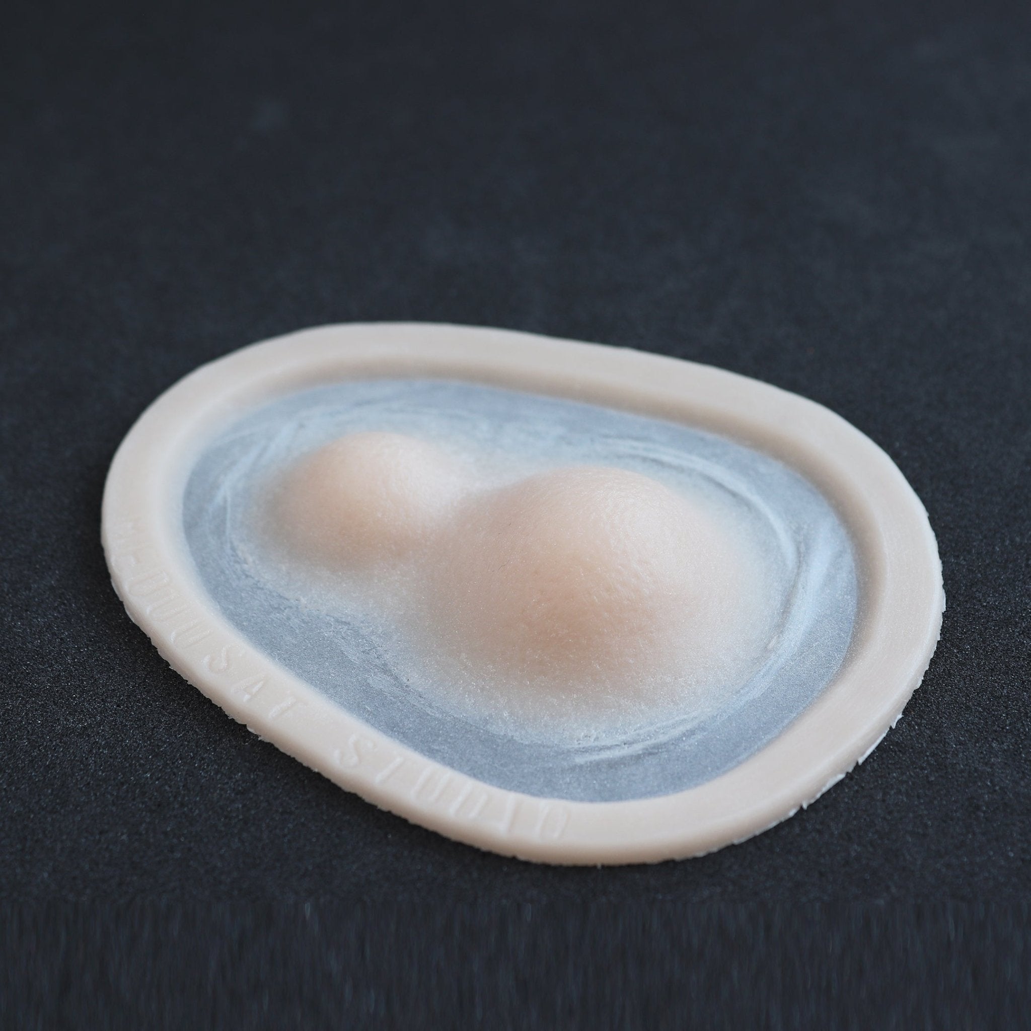 Double Subdermal Horns (Pair) - Silicone makeup prosthetic in vanilla shade on a black surface