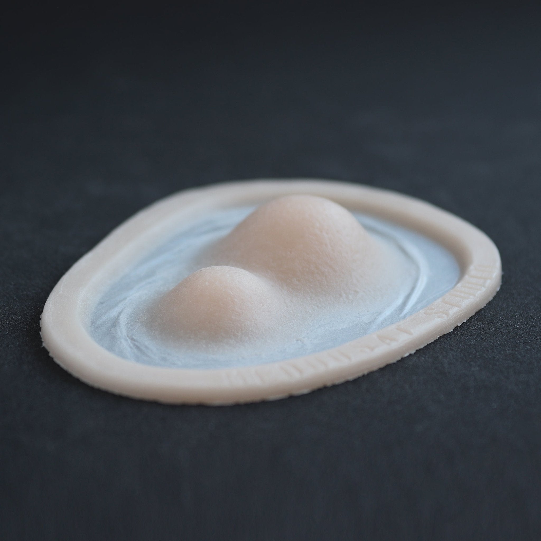 Double Subdermal Horns (Pair) - Silicone makeup prosthetic in vanilla shade on a black surface