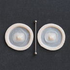 Double Surface Piercing - Silicone makeup prosthetic in vanilla shade on a black surface