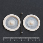 Double Surface Piercing - Silicone makeup prosthetic in vanilla shade on a black surface with a ruler