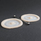 Double Surface Piercing - Silicone makeup prosthetic in vanilla shade on a black surface