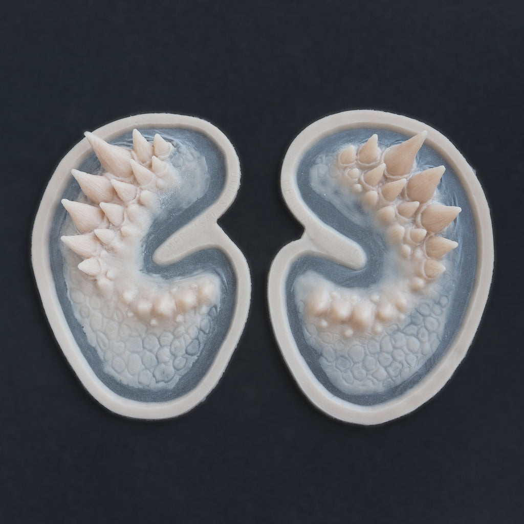 Dragon Half Face - Silicone makeup prosthetic in vanilla shade on a black surface