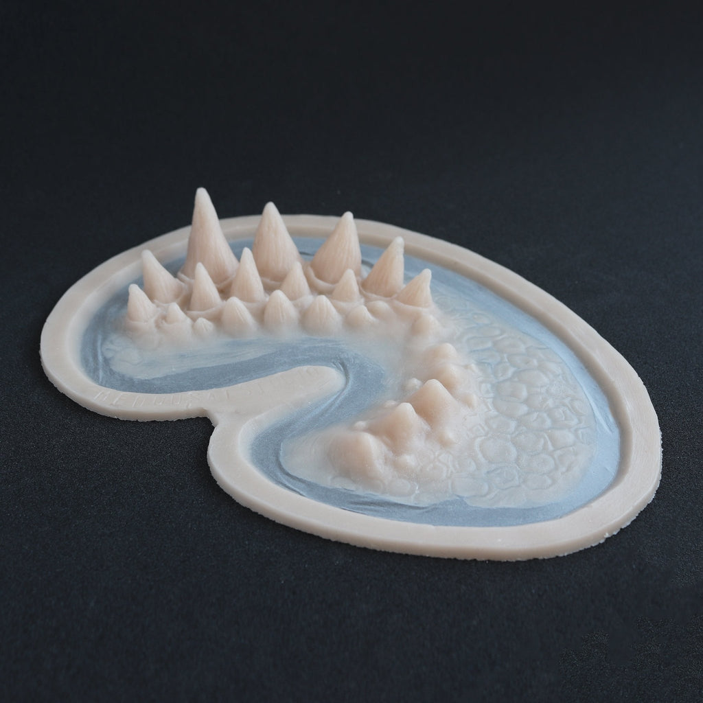 Dragon Half Face - Silicone makeup prosthetic in vanilla shade on a black surface