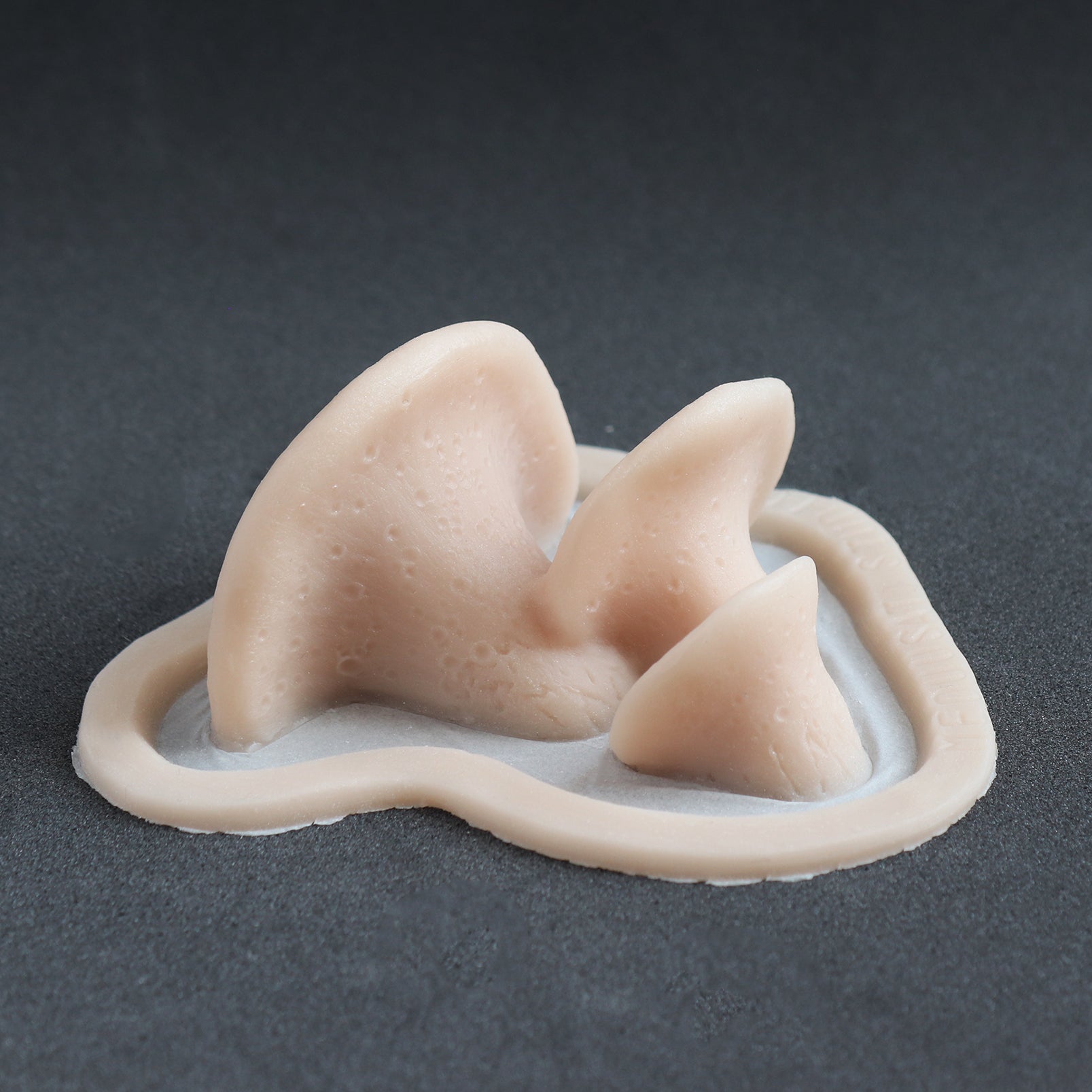 Dryad's Saddle Mushrooms - Silicone makeup prosthetic in vanilla shade on a black surface