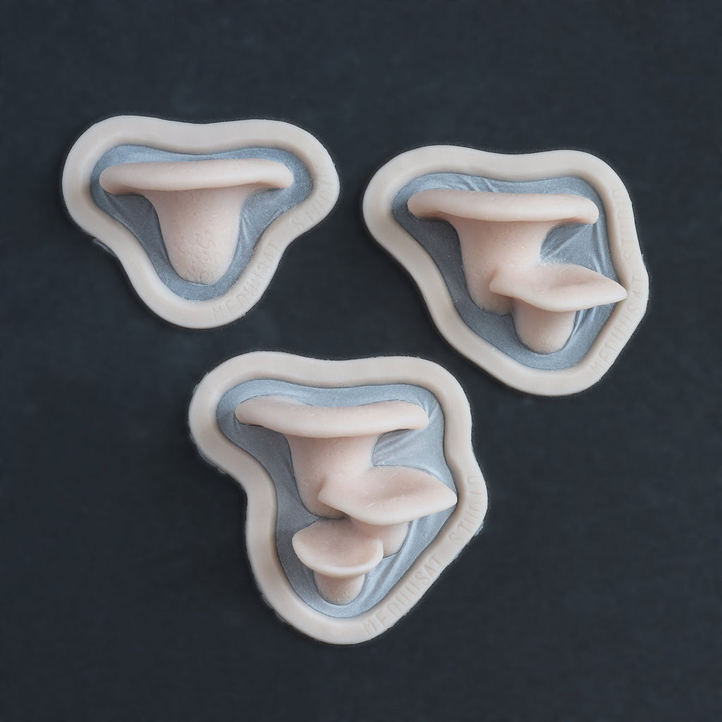Dryad's Saddle Mushrooms - Silicone makeup prosthetic in vanilla shade on a black surface