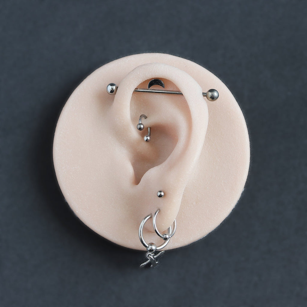 Ear Jewellery Display in vanilla shade on a black surface