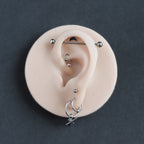 Ear Jewellery Display in vanilla shade on a black surface