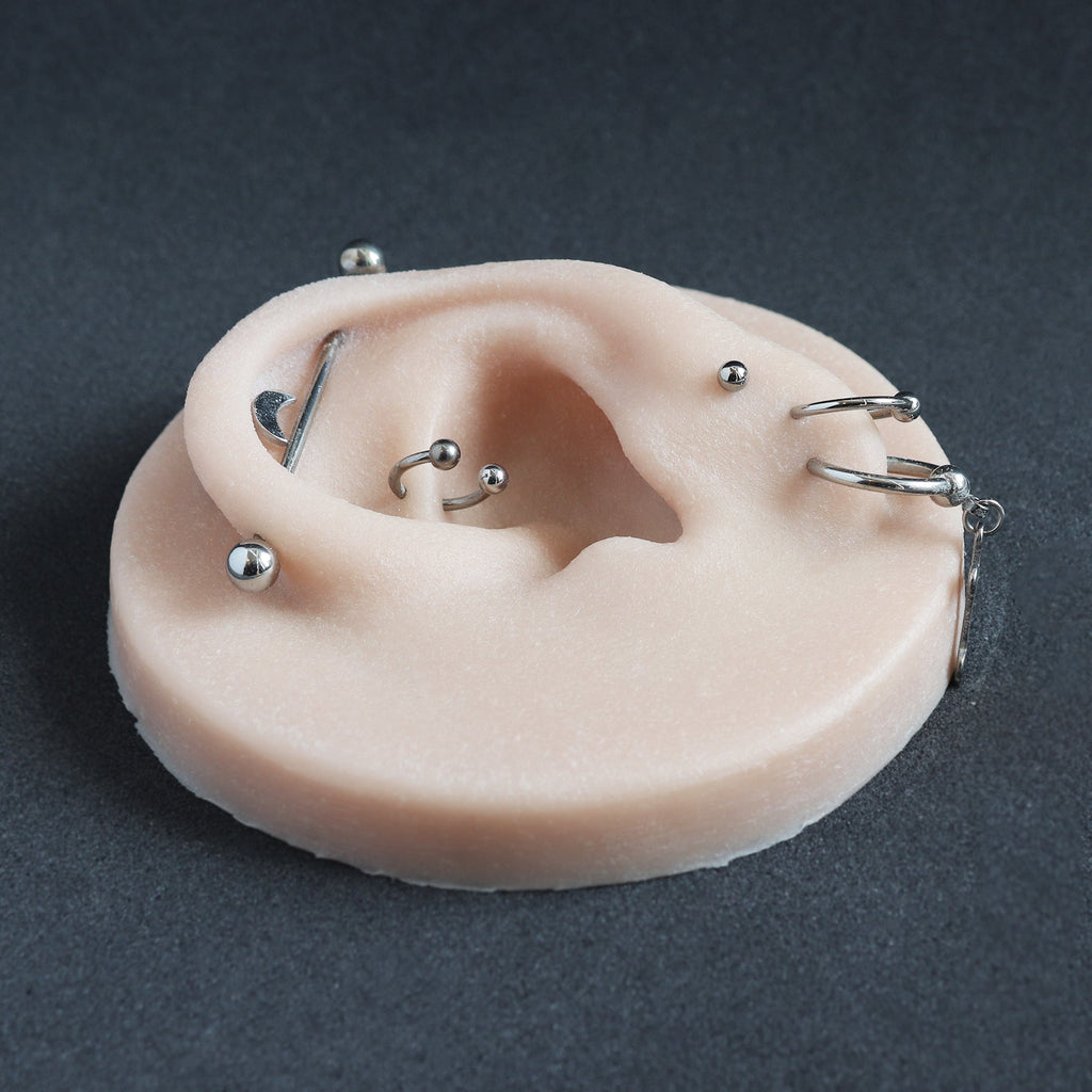 Ear Jewellery Display in vanilla shade on a black surface