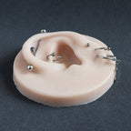 Ear Jewellery Display in vanilla shade on a black surface