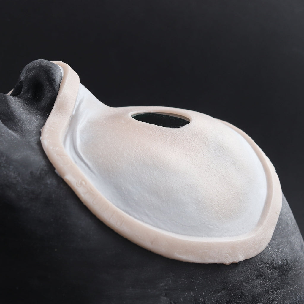 Eyeless - Silicone makeup prosthetic in vanilla shade on a black surface