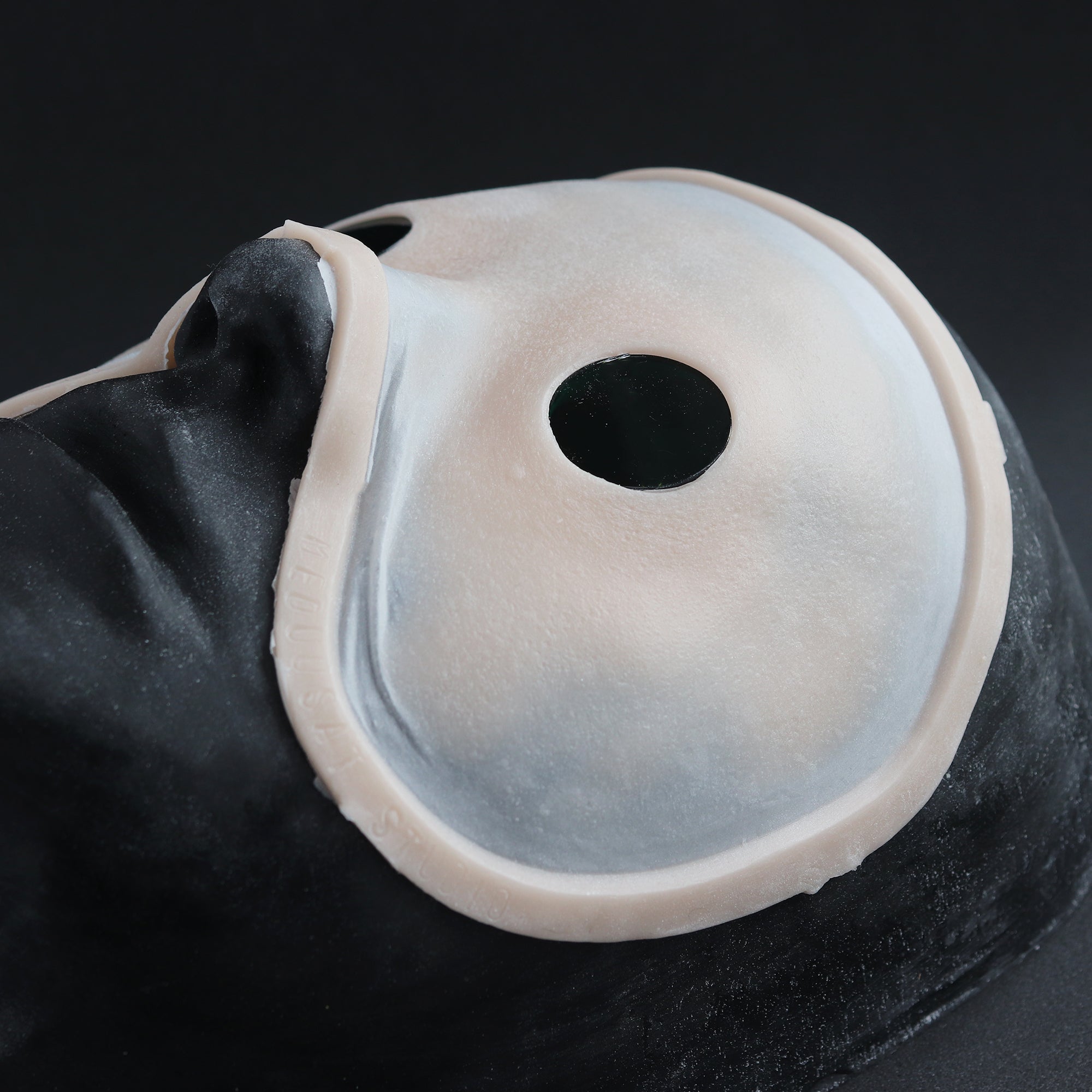 Eyeless - Silicone makeup prosthetic in vanilla shade on a black surface