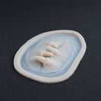 Facial Fangs 2.0 - Silicone makeup prosthetic in vanilla shade on a black surface