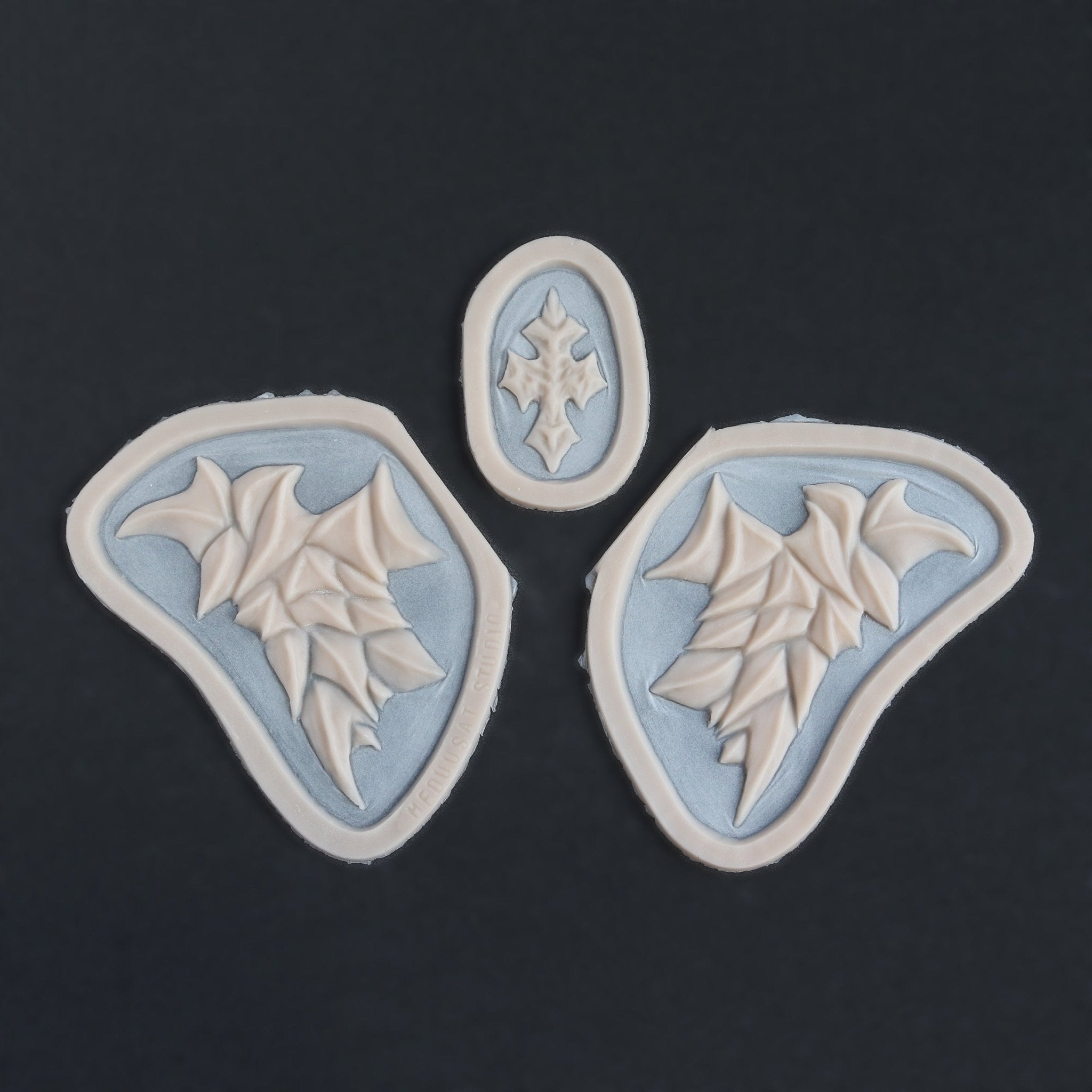 Facial Scales - Silicone makeup prosthetic in vanilla shade on a black surface