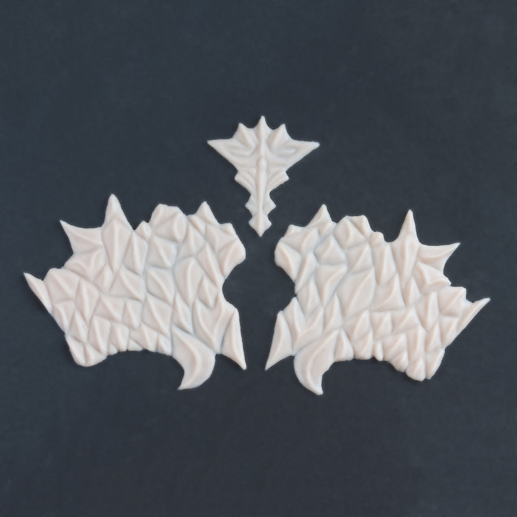 Facial Scales 2.0 - Silicone makeup prosthetic in vanilla shade on a black surface