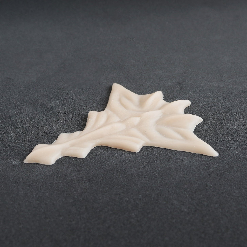 Facial Scales 2.0 - Silicone makeup prosthetic in vanilla shade on a black surface