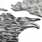 Facial Scales 2.0 - Silicone makeup prosthetic in black on a white surface