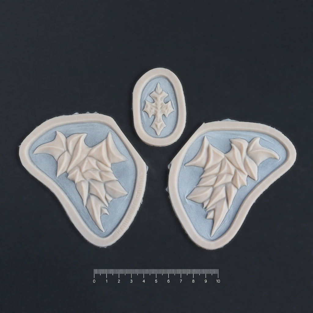 Facial Scales - Silicone makeup prosthetic in vanilla shade on a black surface with a ruler