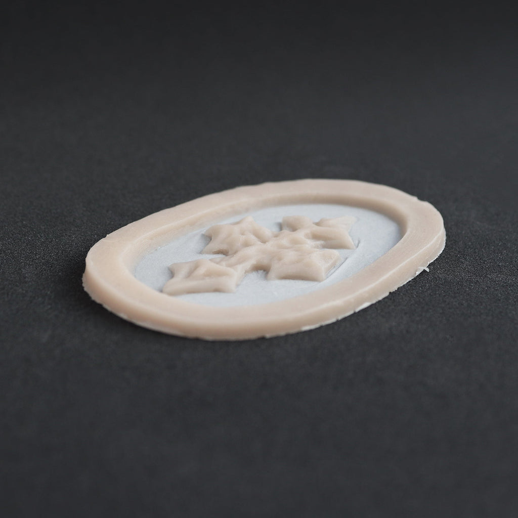 Facial Scales - Silicone makeup prosthetic in vanilla shade on a black surface