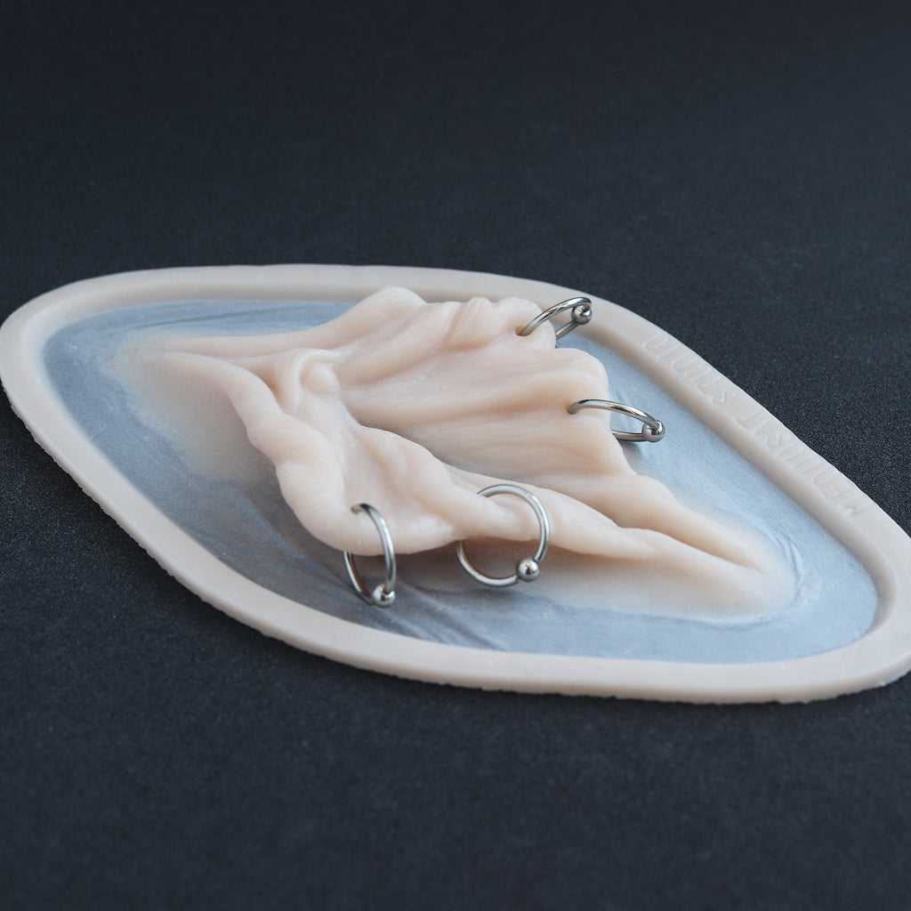 Flower Choker - Silicone makeup prosthetic in vanilla shade on a black surface