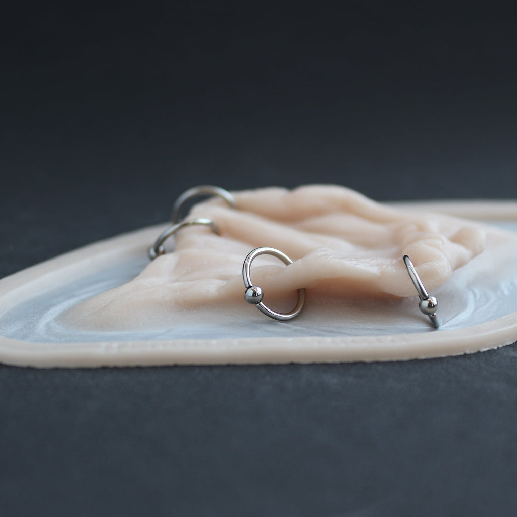 Flower Choker - Silicone makeup prosthetic in vanilla shade on a black surface