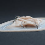 Flower Choker - Silicone makeup prosthetic in vanilla shade on a black surface