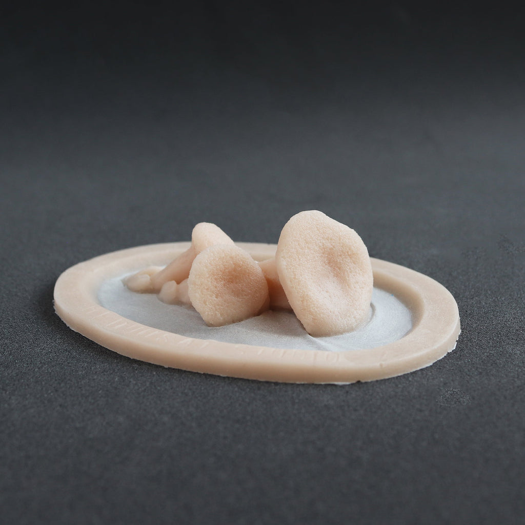 Fungi - Silicone makeup prosthetic in vanilla shade on a black surface