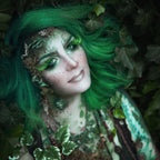 Woman with green hair wearing fungi prosthetics on her face