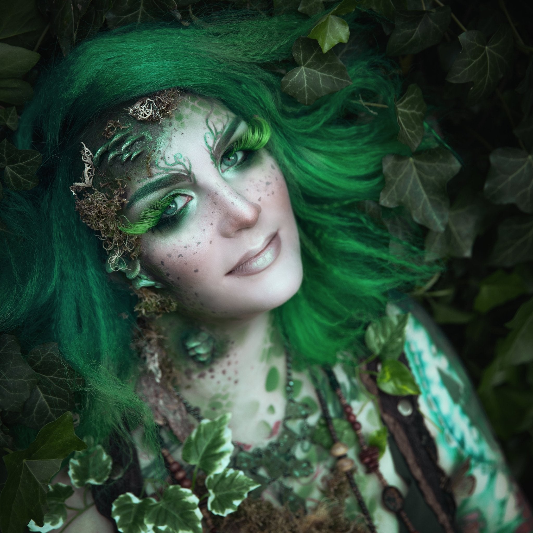 Woman with green hair wearing fungi prosthetics on her face