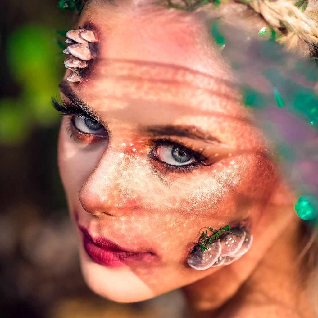 Blond woman with fungi prosthetics on her face