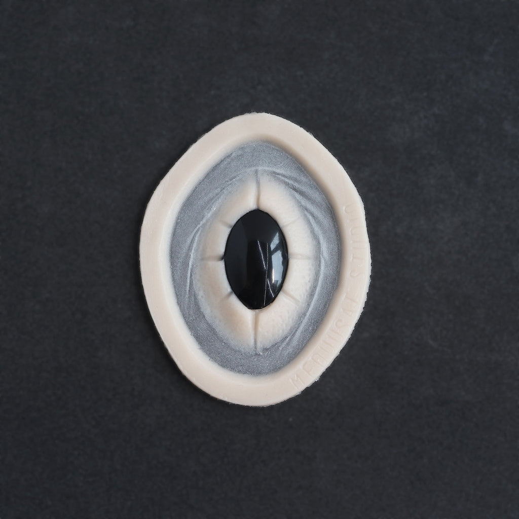 Gem - Silicone makeup prosthetic in vanilla shade on a black surface