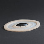 Gem - Silicone makeup prosthetic in vanilla shade on a black surface