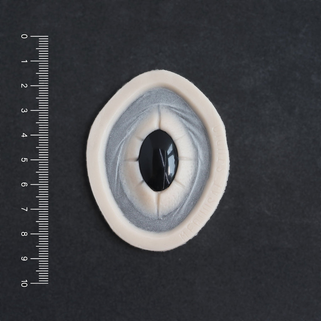 Gem - Silicone makeup prosthetic in vanilla shade on a black surface with a ruler