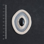 Gem - Silicone makeup prosthetic in vanilla shade on a black surface with a ruler