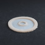 Gunshot Entry Wound - Silicone makeup prosthetic in vanilla shade on a black surface