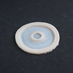 Gunshot Entry Wound - Silicone makeup prosthetic in vanilla shade on a black surface