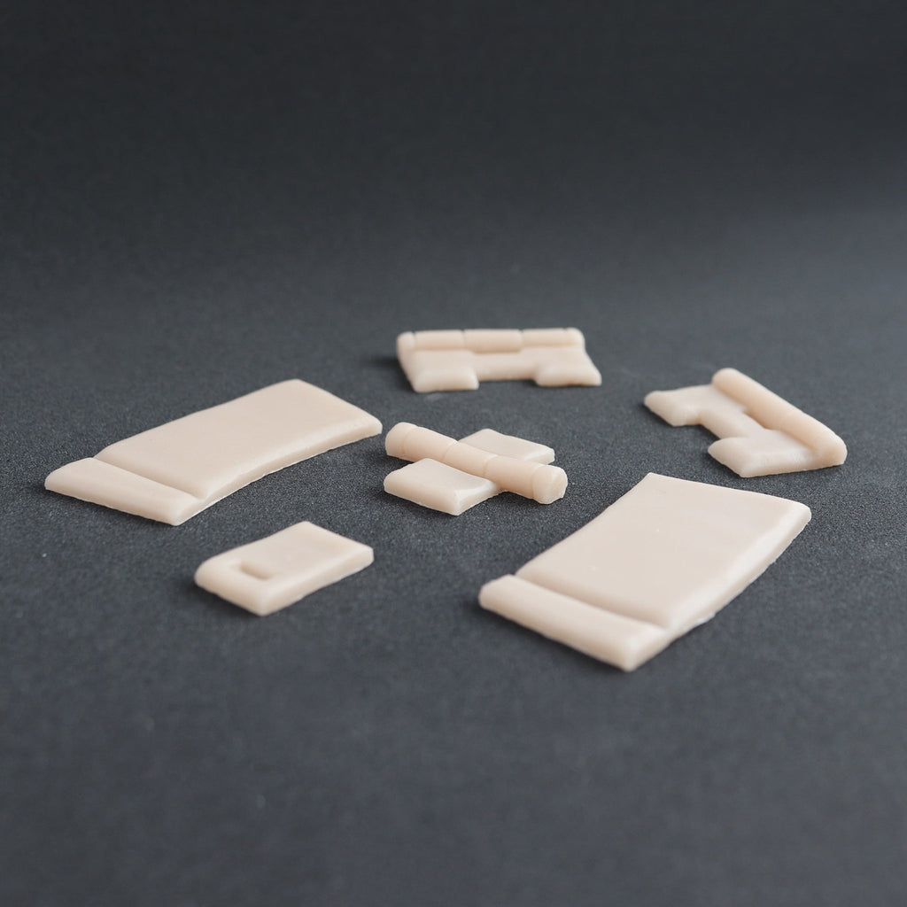 Hinges - Silicone makeup prosthetic in vanilla shade on a black surface