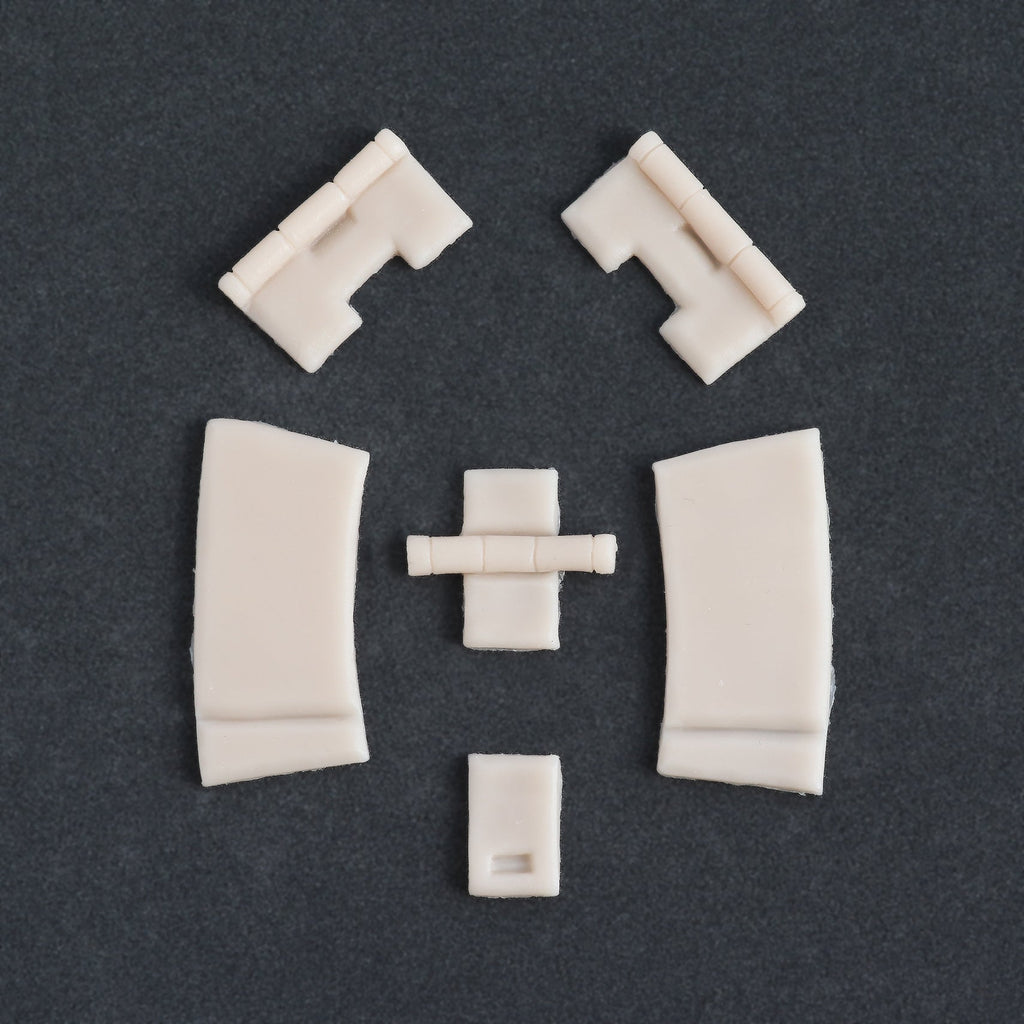 Hinges - Silicone makeup prosthetic in vanilla shade on a black surface