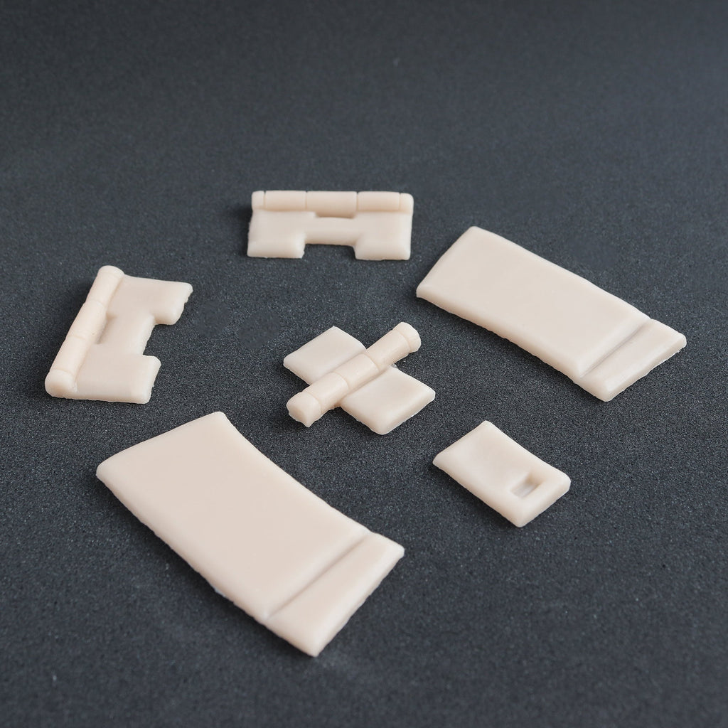 Hinges - Silicone makeup prosthetic in vanilla shade on a black surface