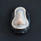 House Elf Nose - Silicone makeup prosthetic in vanilla shade on a black surface