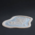 Infected Bite - Silicone makeup prosthetic in vanilla shade on a black surface