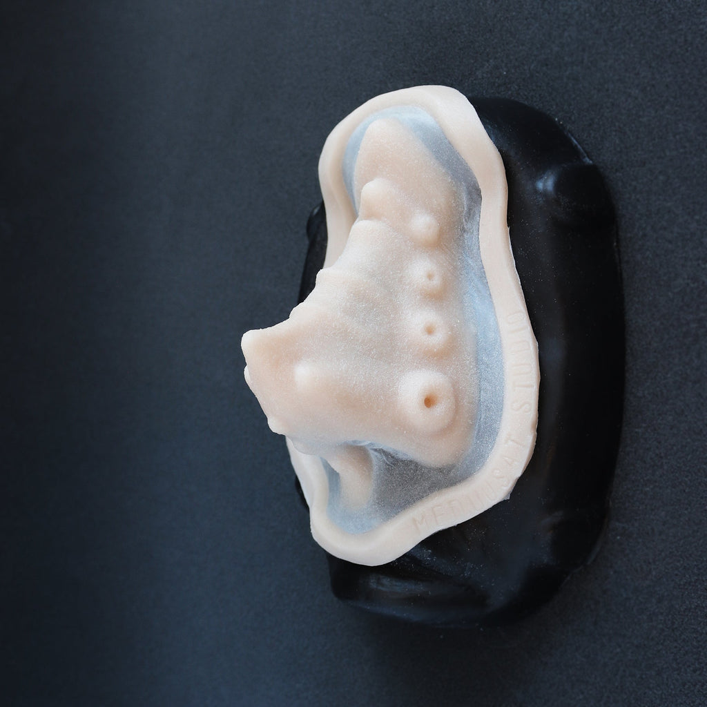 Kraken Nose - Silicone makeup prosthetic in vanilla shade on a black surface
