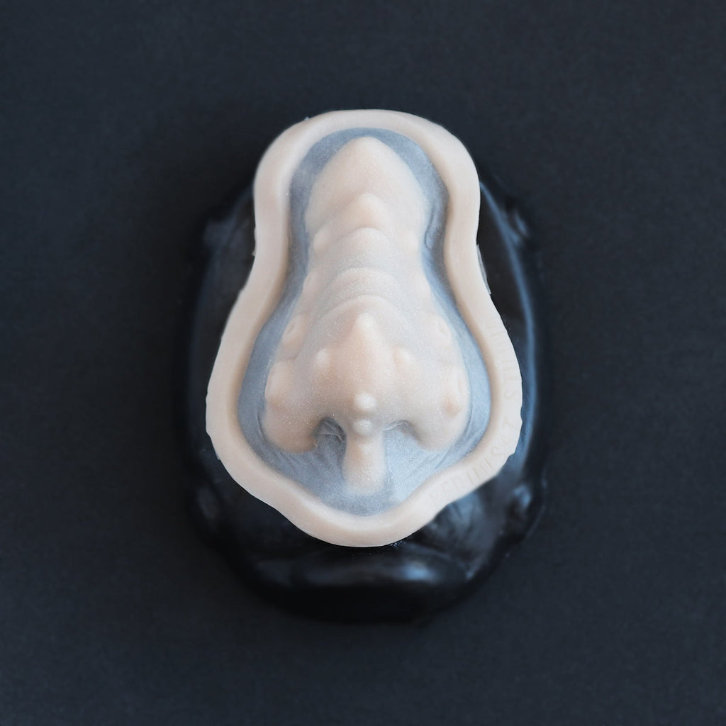 Kraken Nose - Silicone makeup prosthetic in vanilla shade on a black surface