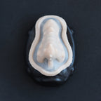 Kraken Nose - Silicone makeup prosthetic in vanilla shade on a black surface