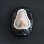 Long Pointy Nose - Silicone makeup prosthetic in vanilla shade on a black surface