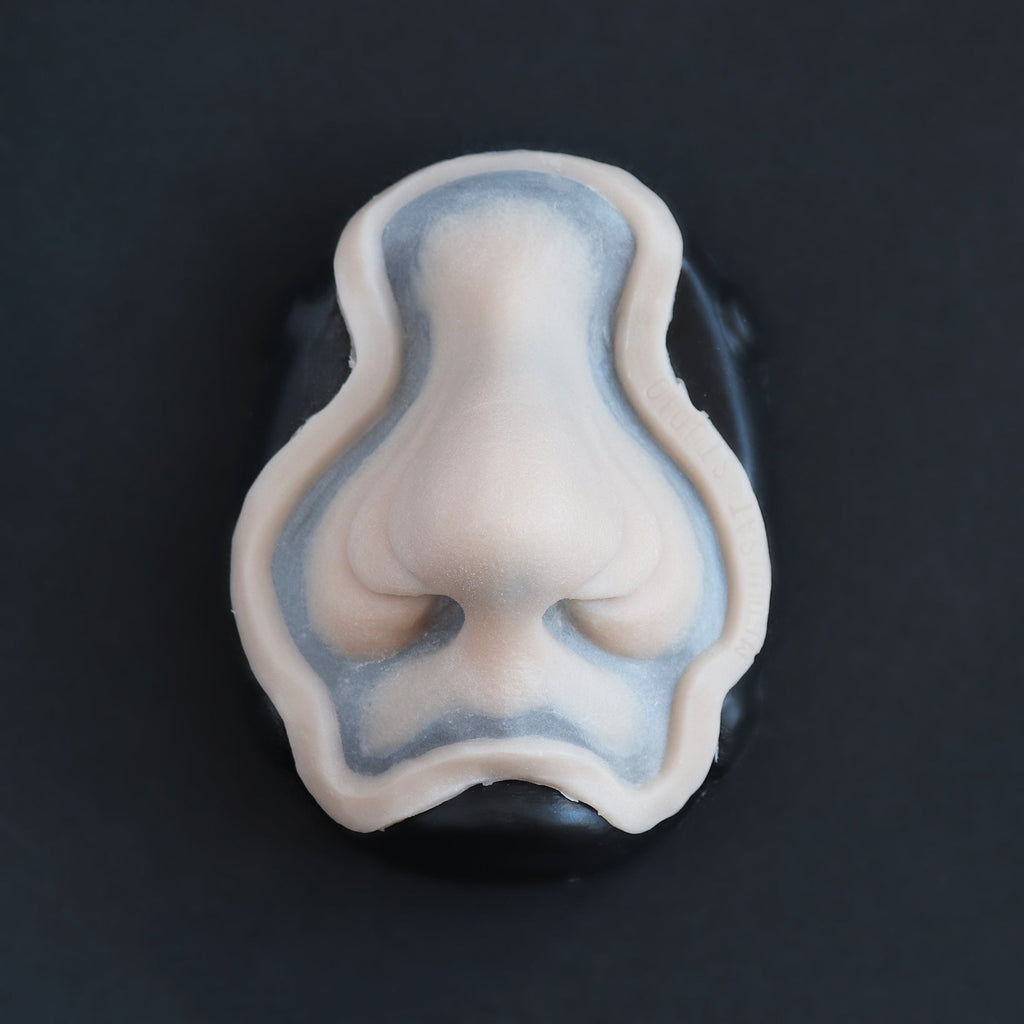 Manta Nose - Silicone makeup prosthetic in vanilla shade on a black surface