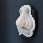 Manta Nose - Silicone makeup prosthetic in vanilla shade on a black surface